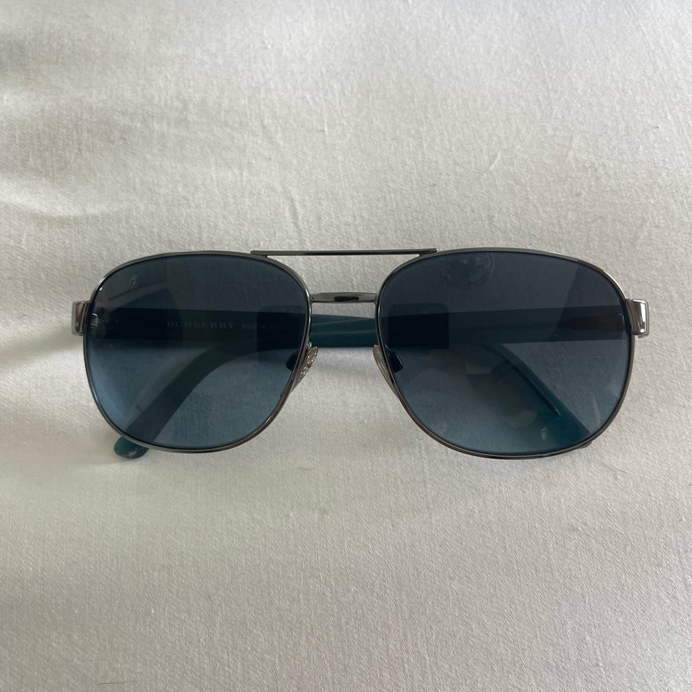 Authentic Burberry sunglasses in excellent condition. Sides are a greenish blue